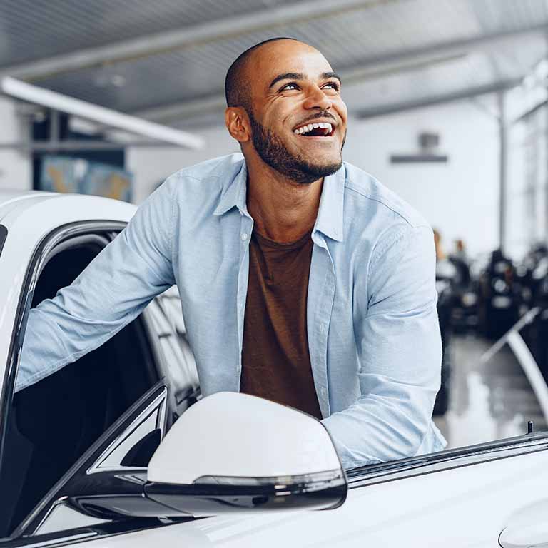 Happy Man Getting In White Car